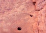 Hole-in-the-Rock -- Uncle Bens' Dugway. These drilled/chiseled holes supported wood stakes which helped secure the rock fill for the road, which was tacked onto the crevice wall. Lamont Crabtree photo